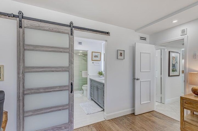 bathroom featuring vanity, hardwood / wood-style floors, a shower with shower door, and toilet