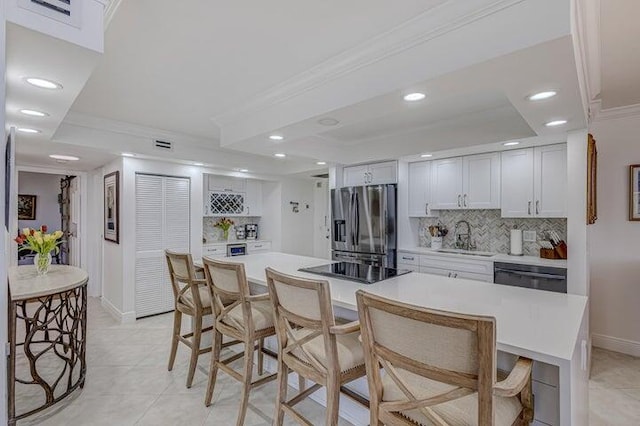 kitchen with white cabinetry, sink, black appliances, and a raised ceiling