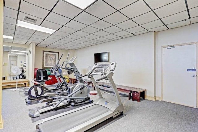 exercise room with carpet and a drop ceiling