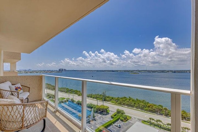 balcony featuring a water view