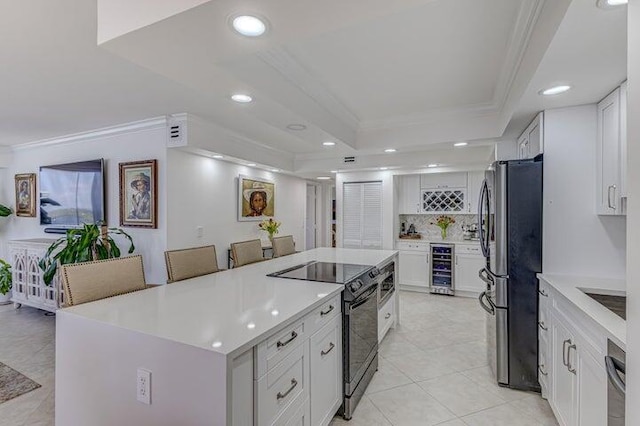 kitchen featuring stainless steel refrigerator, white cabinetry, black electric range oven, and wine cooler