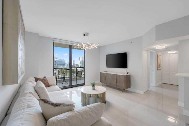 living room with an inviting chandelier and a wall of windows