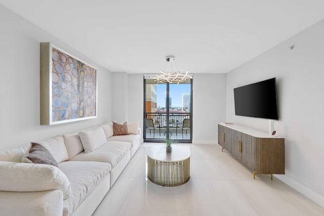 living room with a notable chandelier and a wall of windows