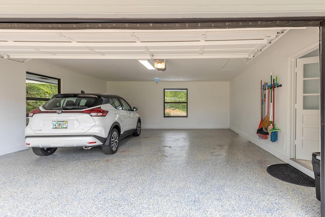 garage featuring baseboards and a garage door opener