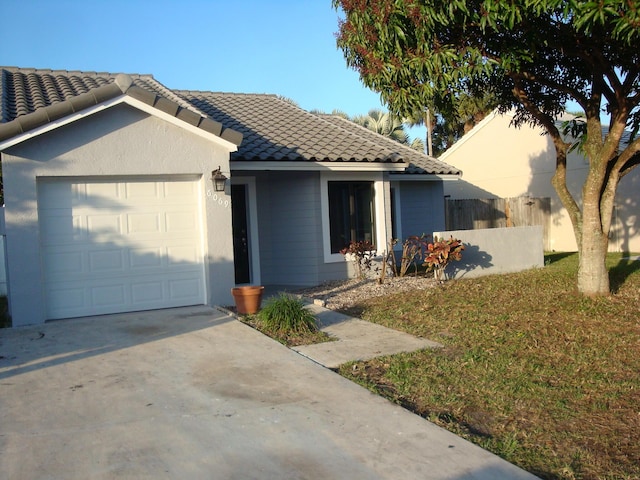 view of front facade with a garage and a front yard