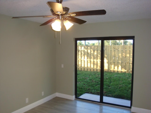 empty room with a textured ceiling and light wood-type flooring