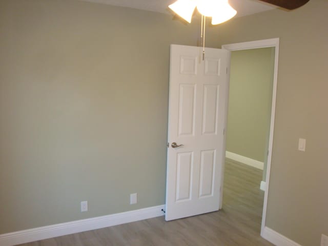 unfurnished room featuring ceiling fan and light hardwood / wood-style flooring