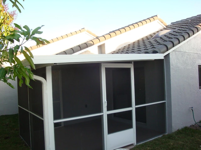 view of side of home with a sunroom