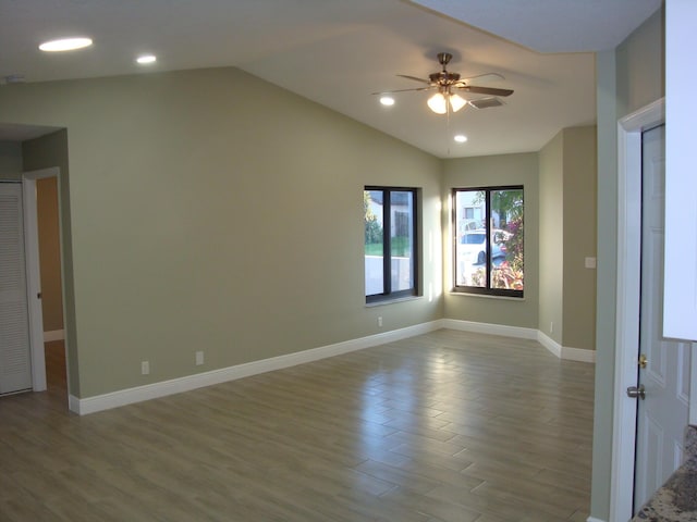 unfurnished room featuring vaulted ceiling, hardwood / wood-style floors, and ceiling fan