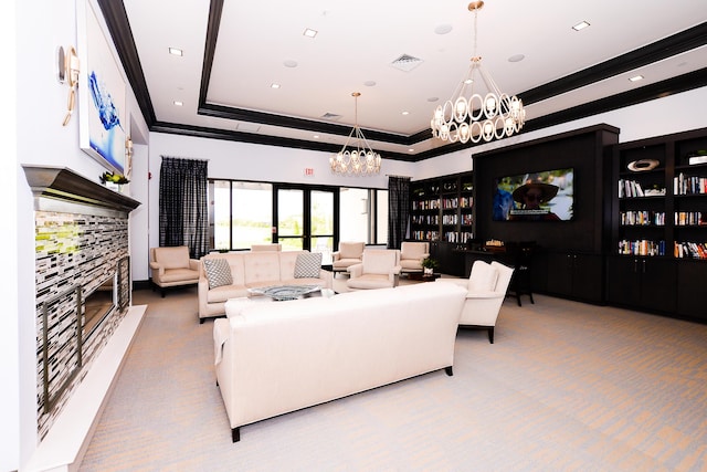 living room featuring an inviting chandelier, ornamental molding, carpet, a raised ceiling, and visible vents