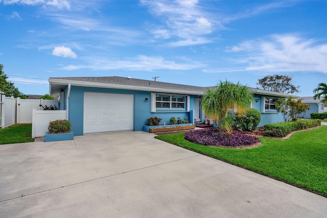 ranch-style home featuring a garage, concrete driveway, fence, a front lawn, and stucco siding