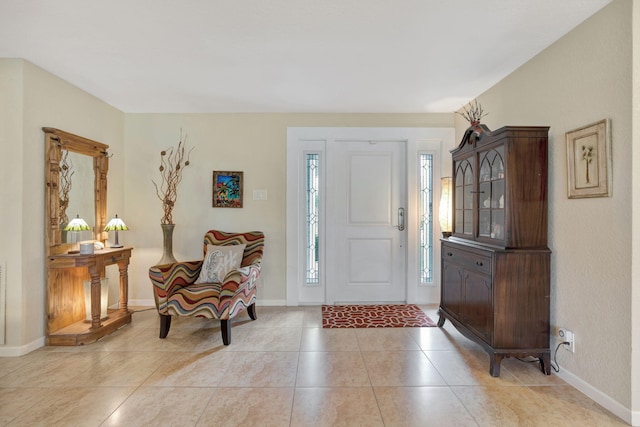 entryway featuring light tile patterned floors and baseboards