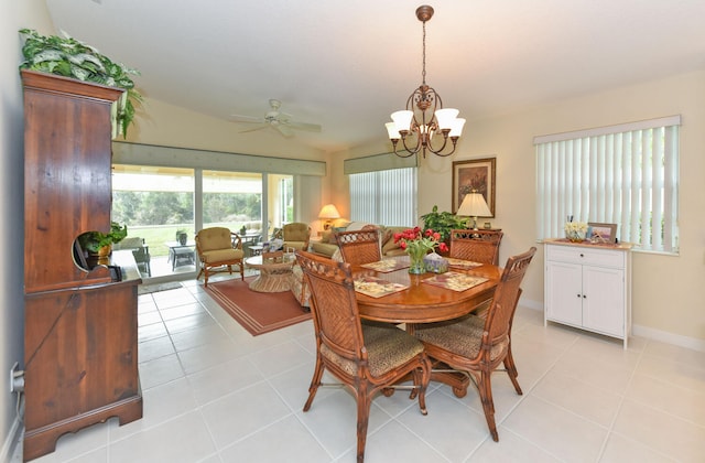 dining room with ceiling fan with notable chandelier and light tile patterned floors