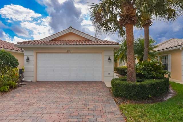 mediterranean / spanish-style home with a garage