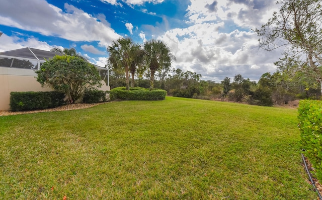 view of yard featuring a lanai