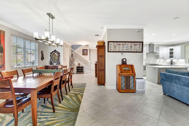 dining room with stairs, ornamental molding, light tile patterned flooring, and an inviting chandelier