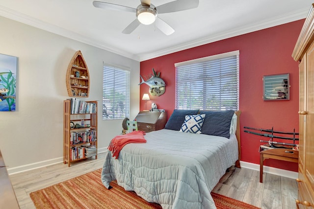 bedroom featuring crown molding, baseboards, and wood finished floors