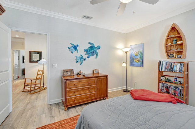 bedroom featuring crown molding, visible vents, light wood-style flooring, ceiling fan, and baseboards