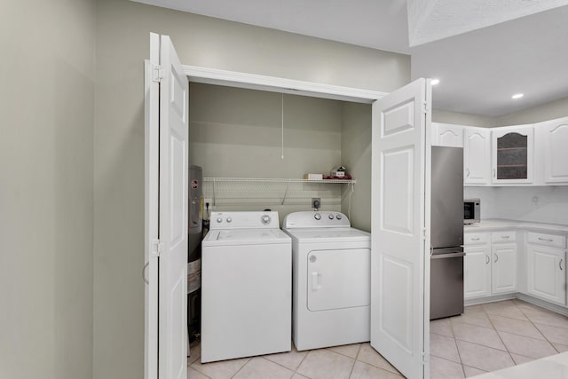 laundry area featuring light tile patterned flooring, washer and clothes dryer, and laundry area