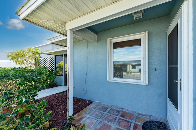 doorway to property with stucco siding