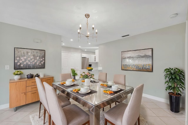 dining room with light tile patterned flooring, baseboards, a chandelier, and visible vents