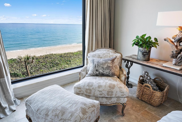 sitting room with a water view and a beach view