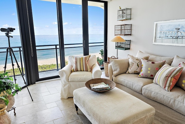 living room featuring floor to ceiling windows and a water view