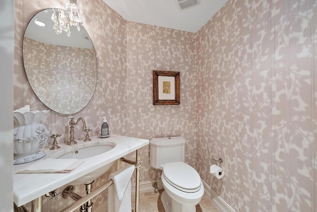 bathroom with tile patterned flooring, sink, and toilet