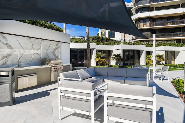 view of patio / terrace featuring an outdoor kitchen, a grill, sink, and outdoor lounge area