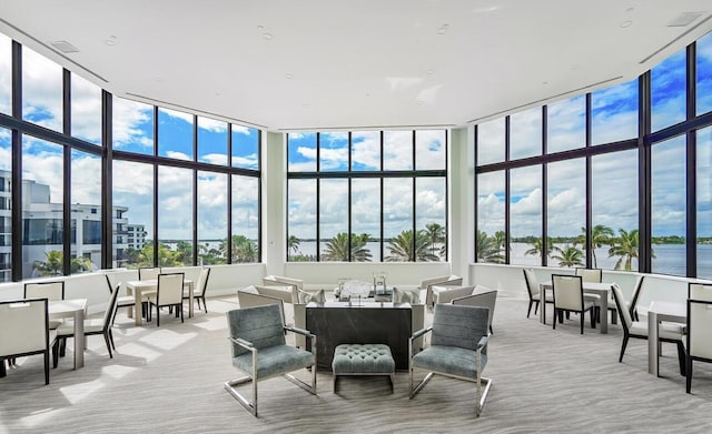 sunroom with a water view and plenty of natural light