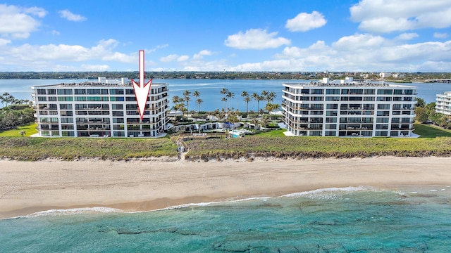 birds eye view of property with a water view and a view of the beach