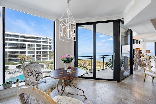 dining room with crown molding, a wall of windows, and a water view