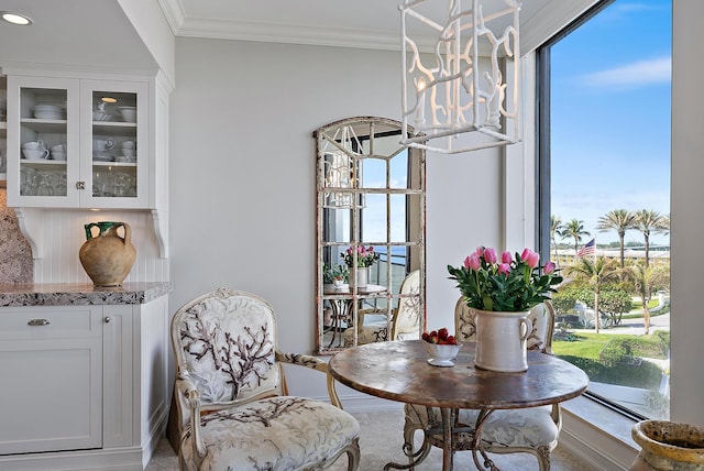 dining space featuring an inviting chandelier and crown molding