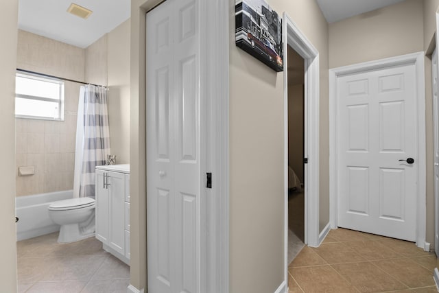 bathroom with tile patterned flooring, visible vents, toilet, and shower / tub combo with curtain