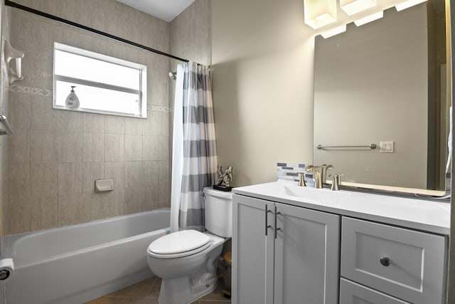 full bath featuring tile patterned floors, shower / bath combination with curtain, toilet, and vanity