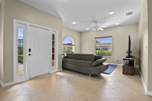 entrance foyer featuring visible vents, baseboards, light tile patterned flooring, and a ceiling fan