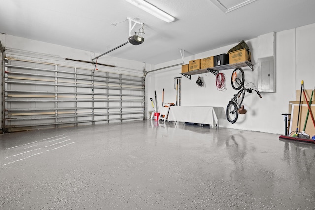 garage with electric panel and a garage door opener