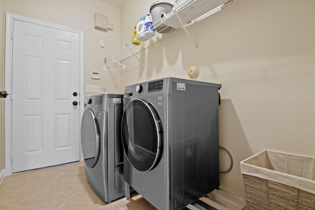 laundry room with light tile patterned floors, laundry area, and washer and dryer