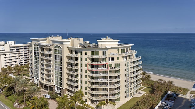 view of property featuring a water view and a beach view