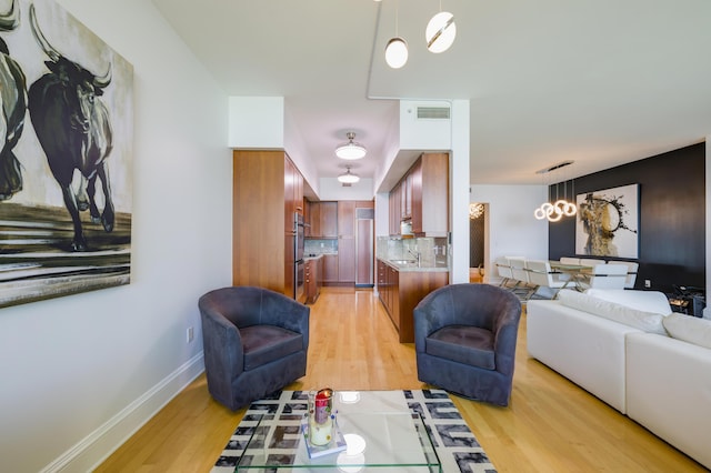 living room with sink and light wood-type flooring