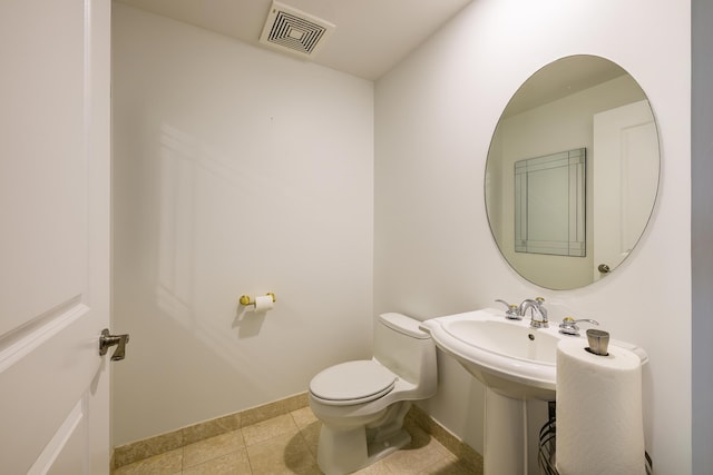 bathroom with tile patterned floors and toilet