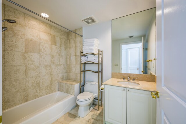 full bathroom with vanity, tile patterned flooring, tiled shower / bath combo, and toilet