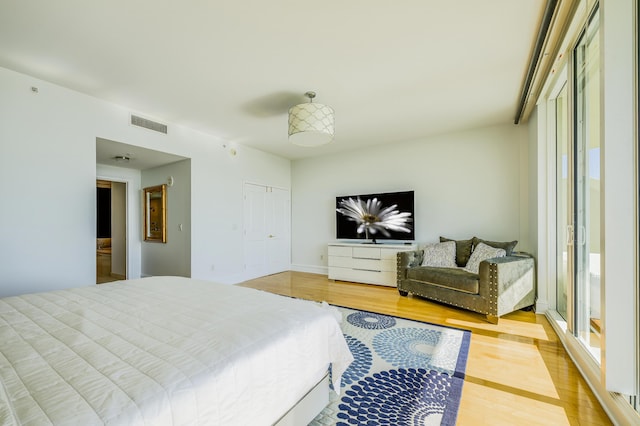 bedroom with a closet and light hardwood / wood-style flooring