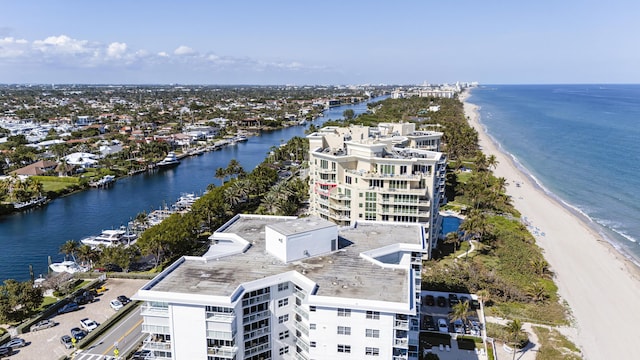 aerial view with a water view and a beach view