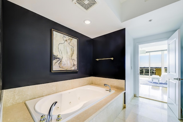 bathroom with tile patterned floors and tiled bath