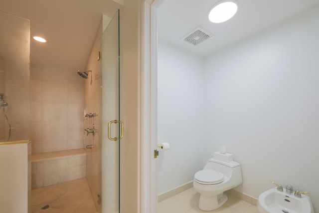 bathroom with a bidet, toilet, tile patterned floors, and walk in shower