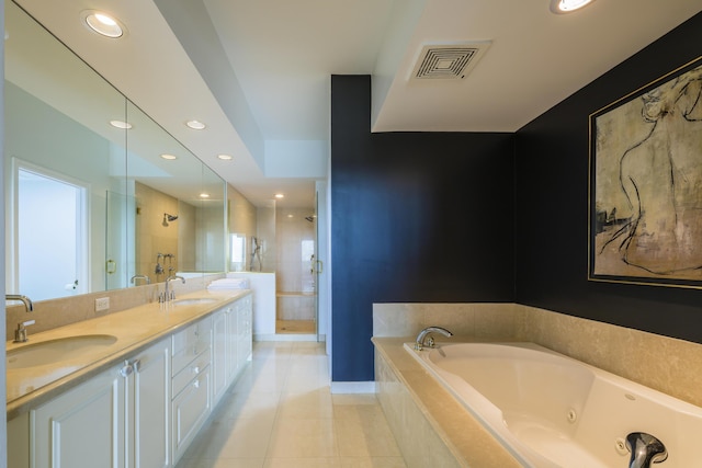 bathroom with tile patterned flooring, vanity, and shower with separate bathtub