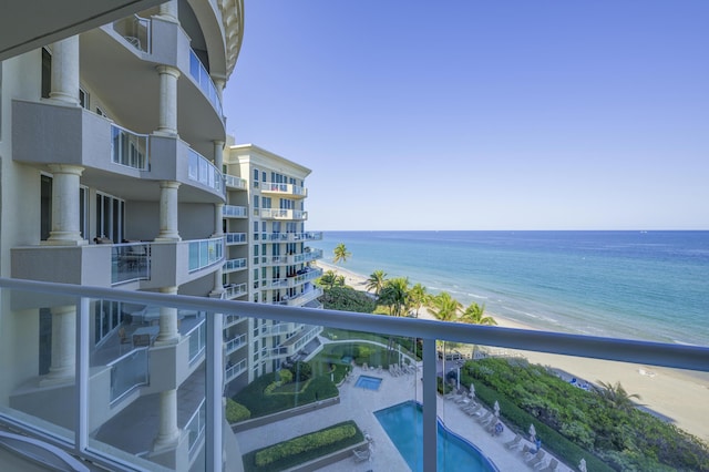 balcony featuring a water view and a view of the beach