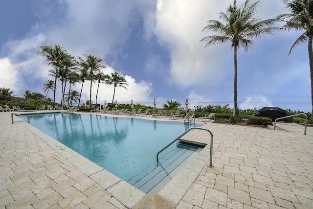 view of pool featuring grilling area and a patio area