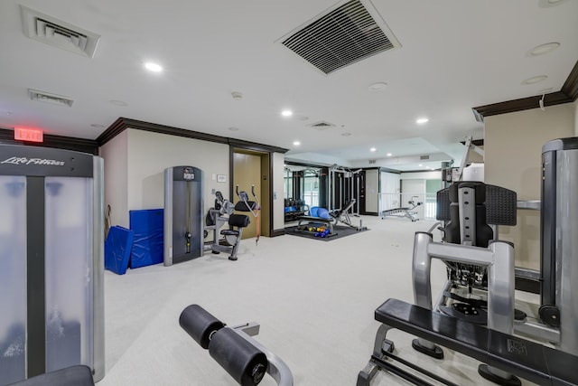 workout area with ornamental molding and light colored carpet